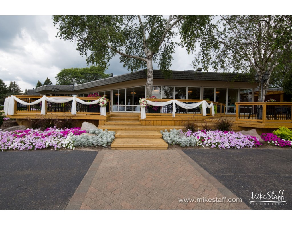 view of clubhouse with flowers and drapery adorning the clubhouse for wedding